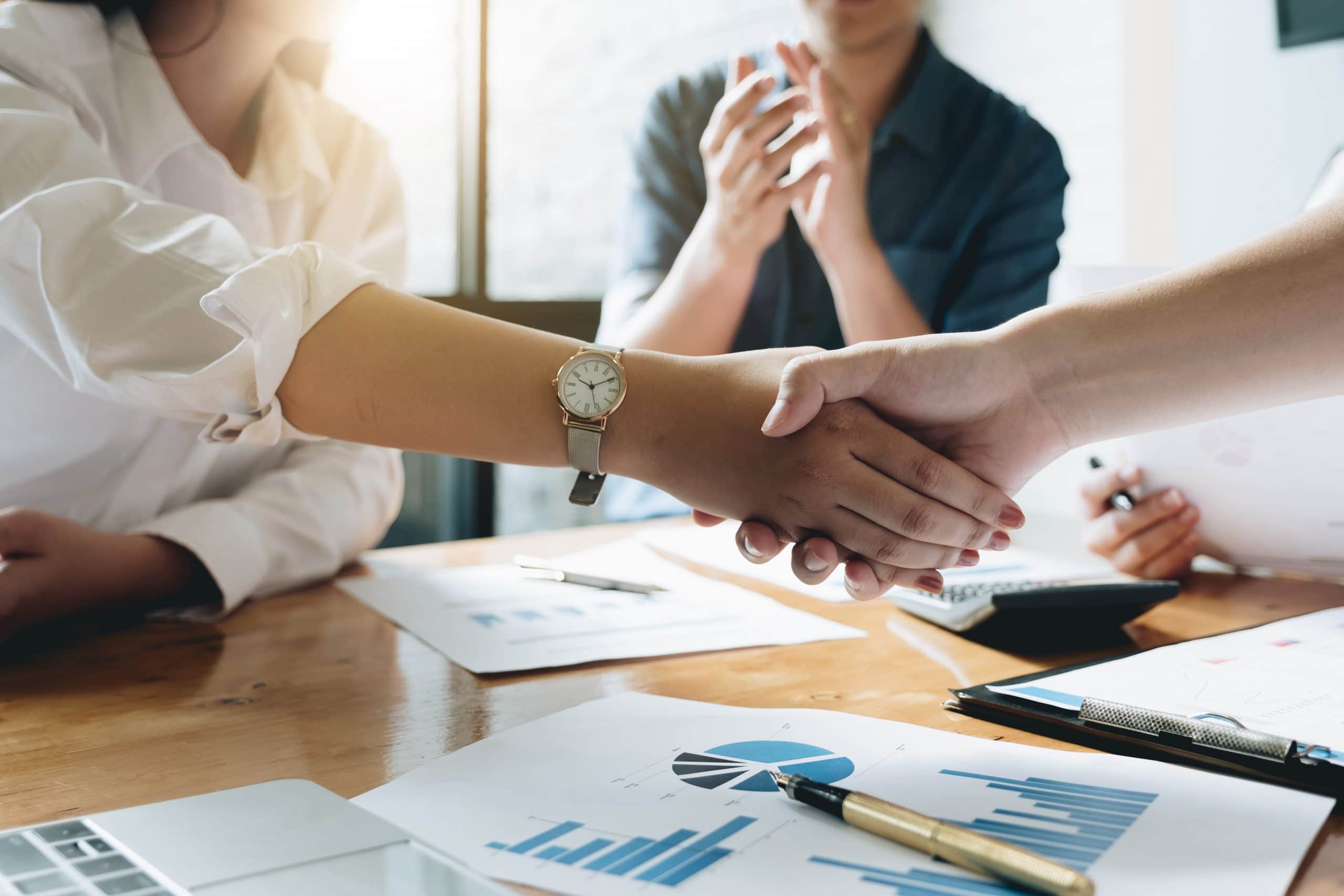 Close up of Business people shaking hands, finishing up meeting, business etiquette, congratulation, post merger integration and acquisition concept