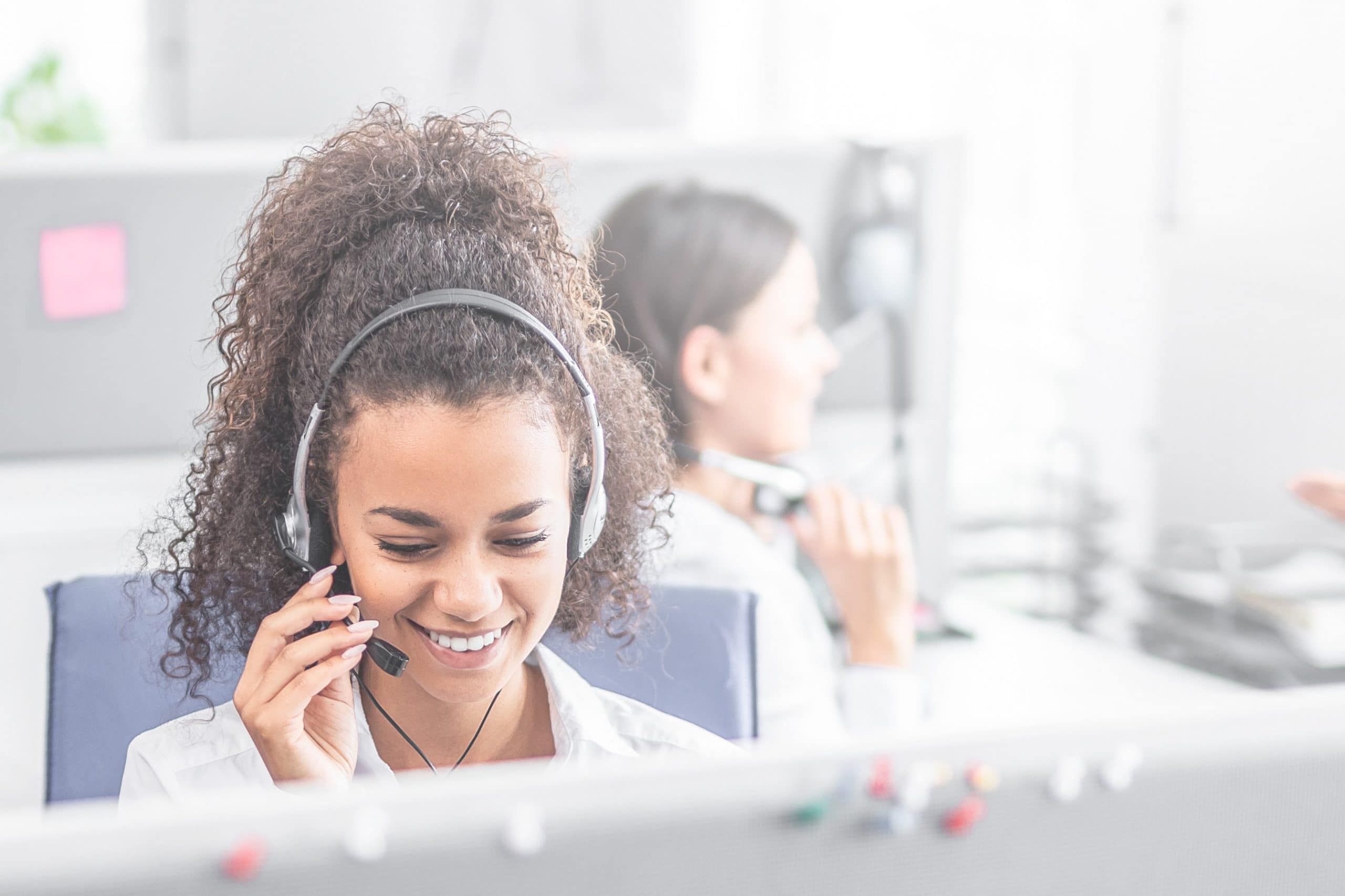 A frontline employee takes a call on a headset