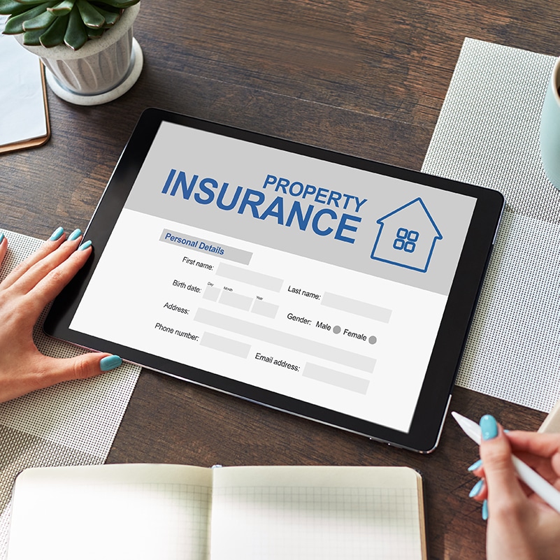 Woman completes online property insurance application on a tablet - The future of insurance distribution
