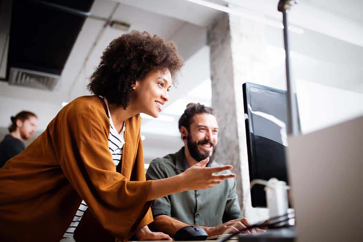 Two coworkers collaborate on a business process
