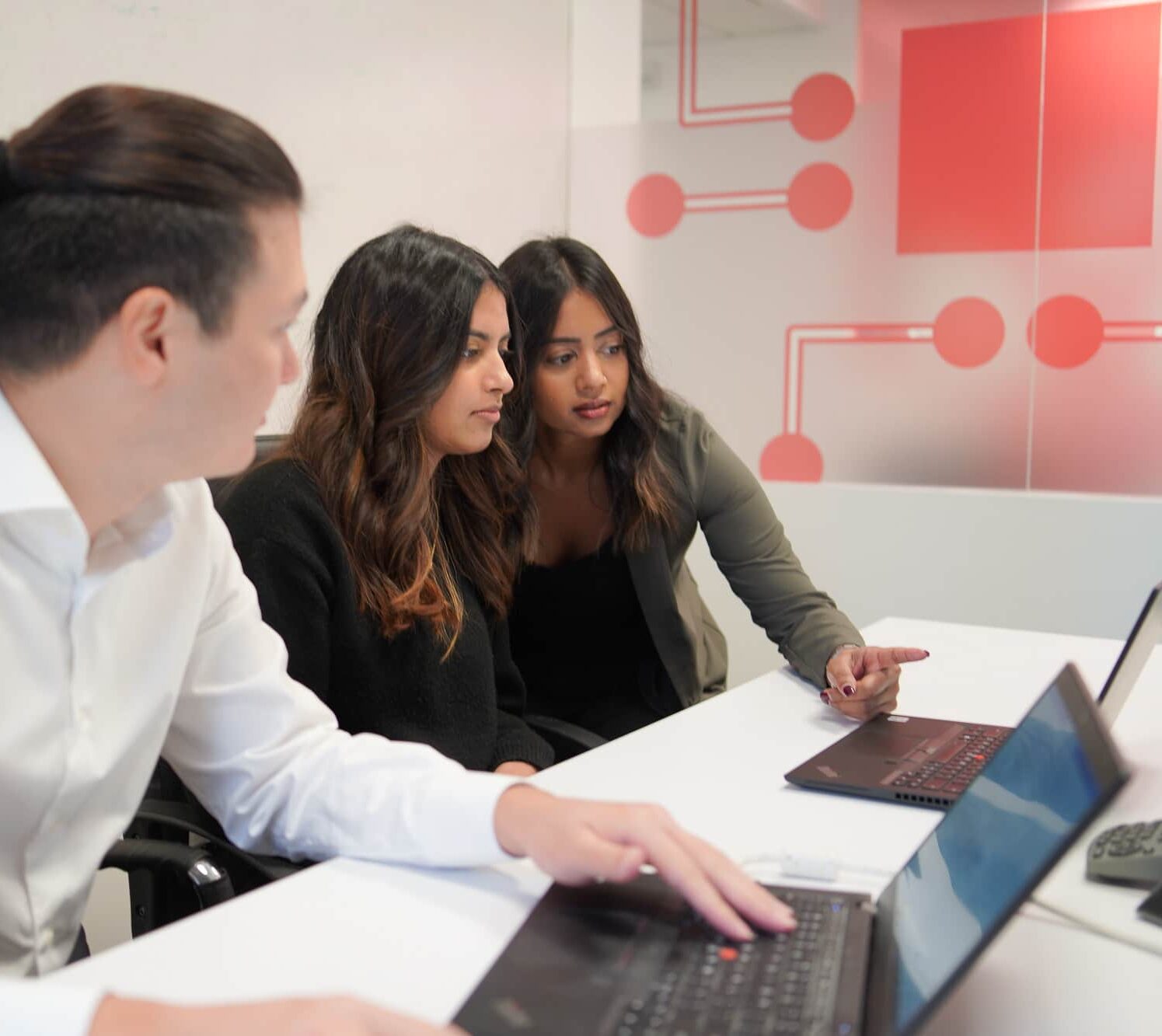 Three team members work together to resolve issues