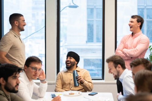 Consultants on the Burnie Group team eat lunch in a kitchen that faces Bay Street, Toronto