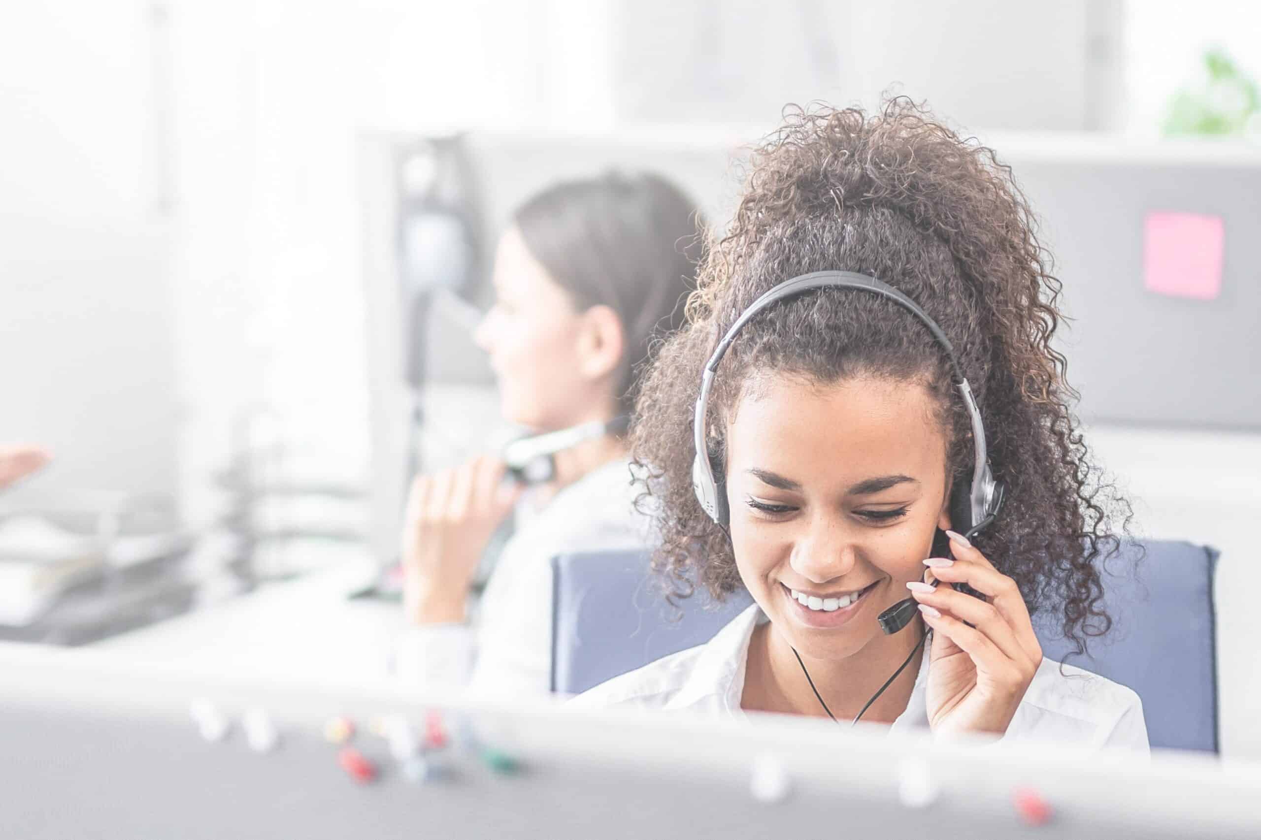 Frontline employee in a call center accompanied by her team