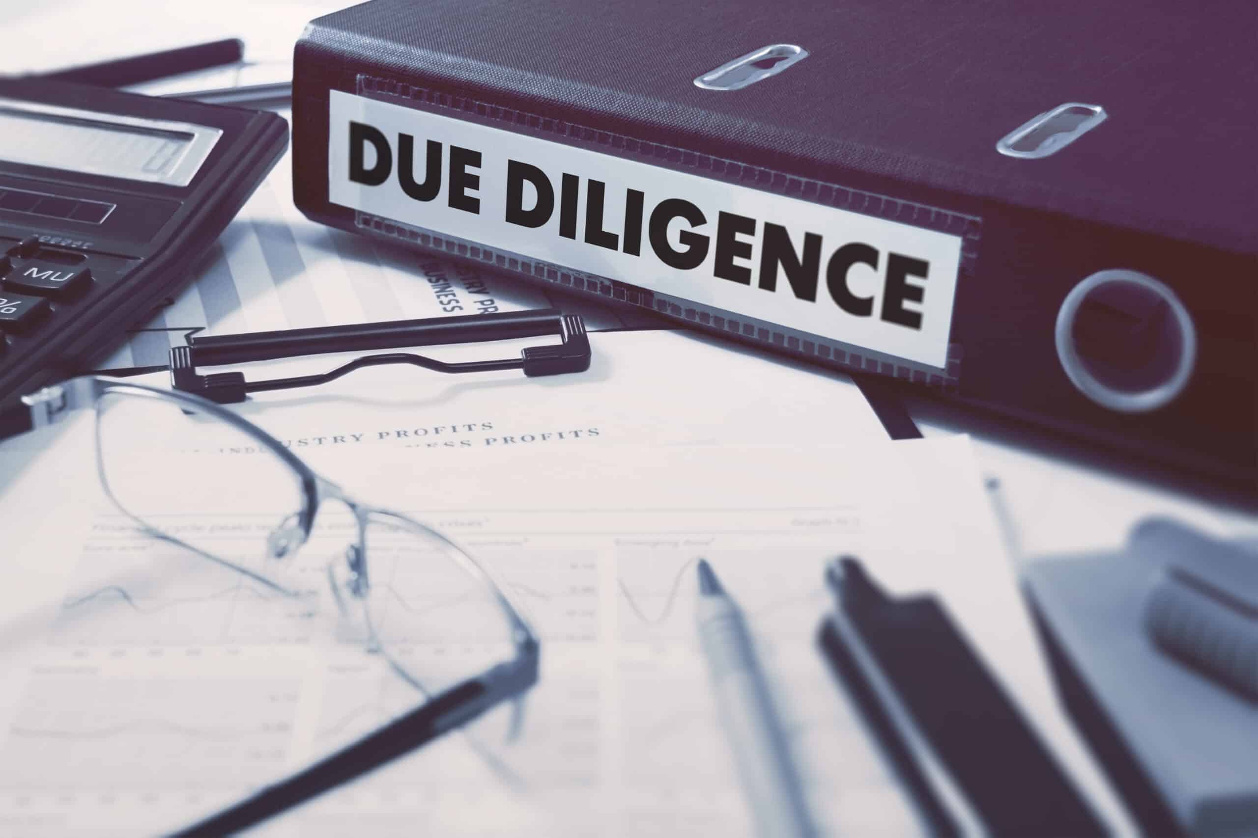 Due Diligence - Ring Binder on Office Desktop with Office Supplies
