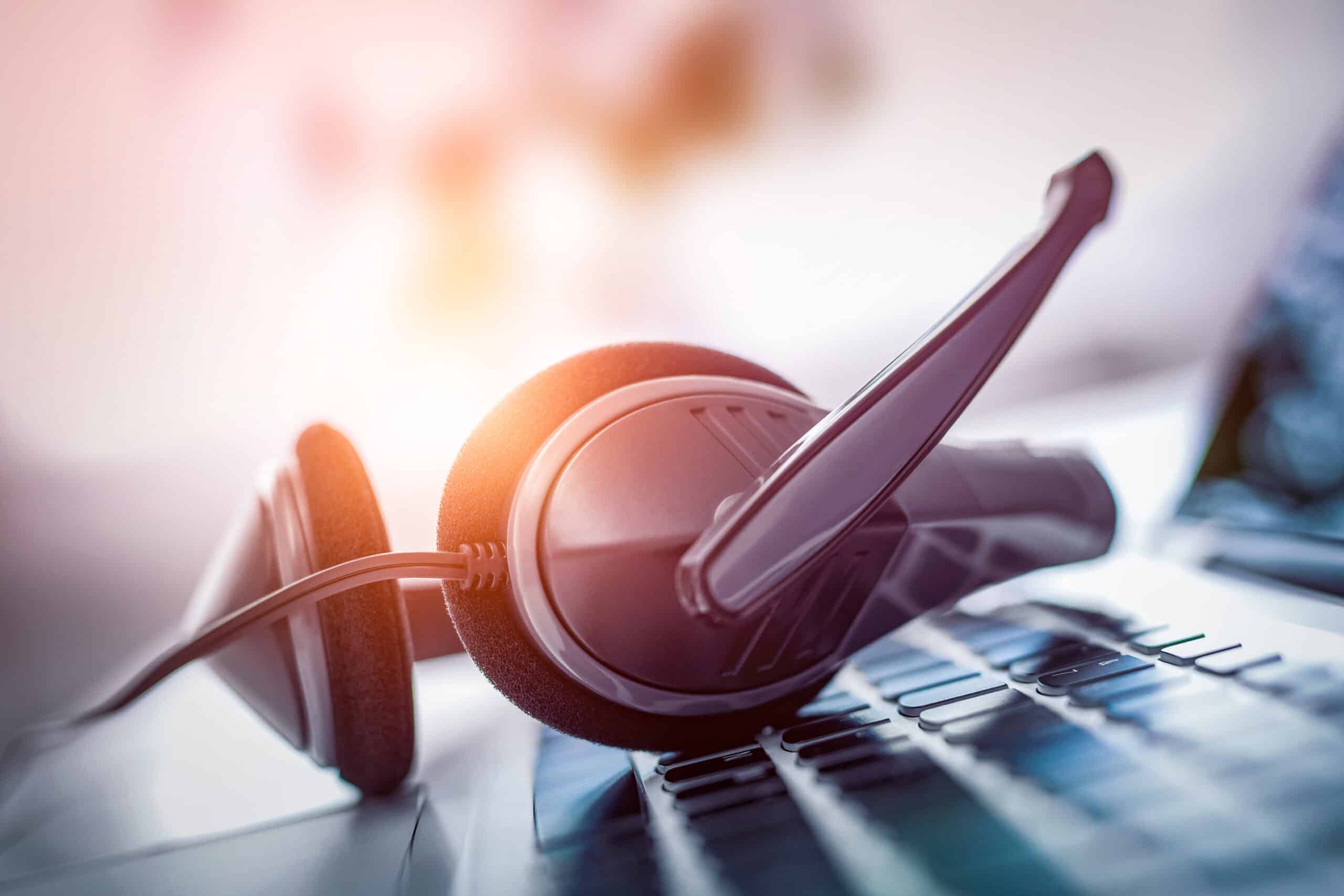 Contact center technology - headset resting on a keyboard