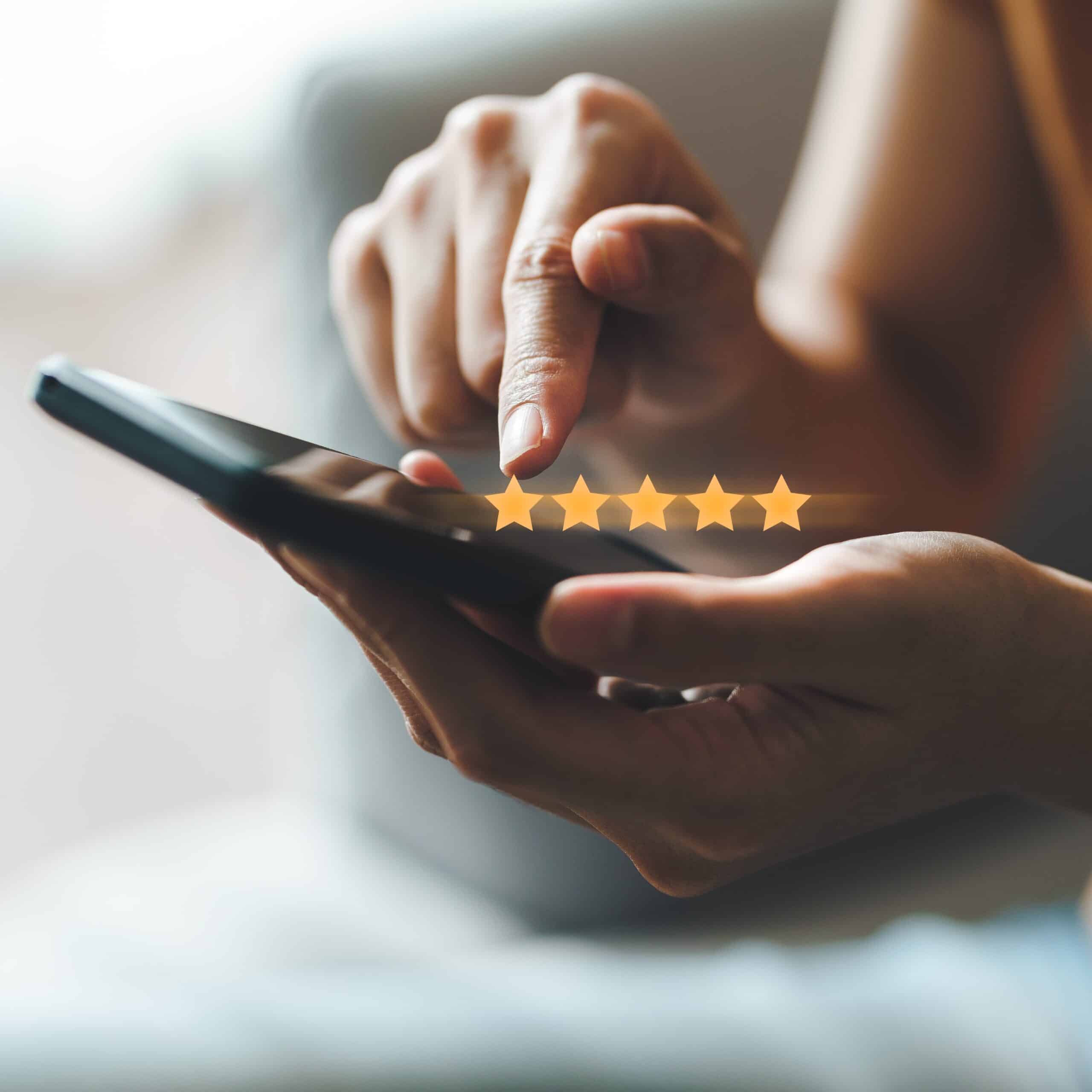 Close up of a customer giving a five star rating on smartphone. Review, Service rating, satisfaction, Customer service experience and satisfaction survey