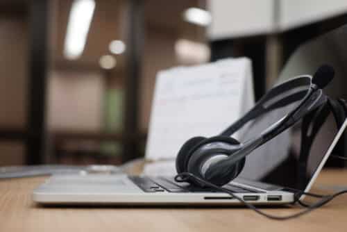 Close Up,Blurred, Headset Of Call Centre With Laptop and Script