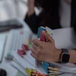 People in suits working through paper files