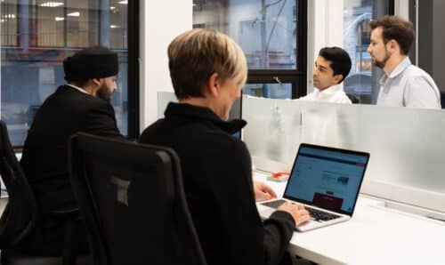 s group of colleagues working in an office environment.